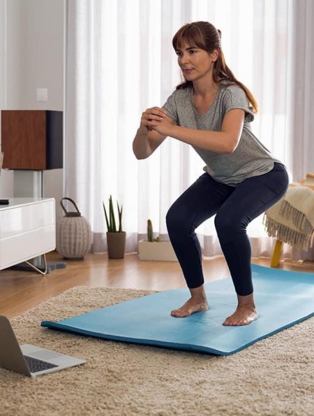 Beginner doing simple exercises at home for weight loss and fitness improvement